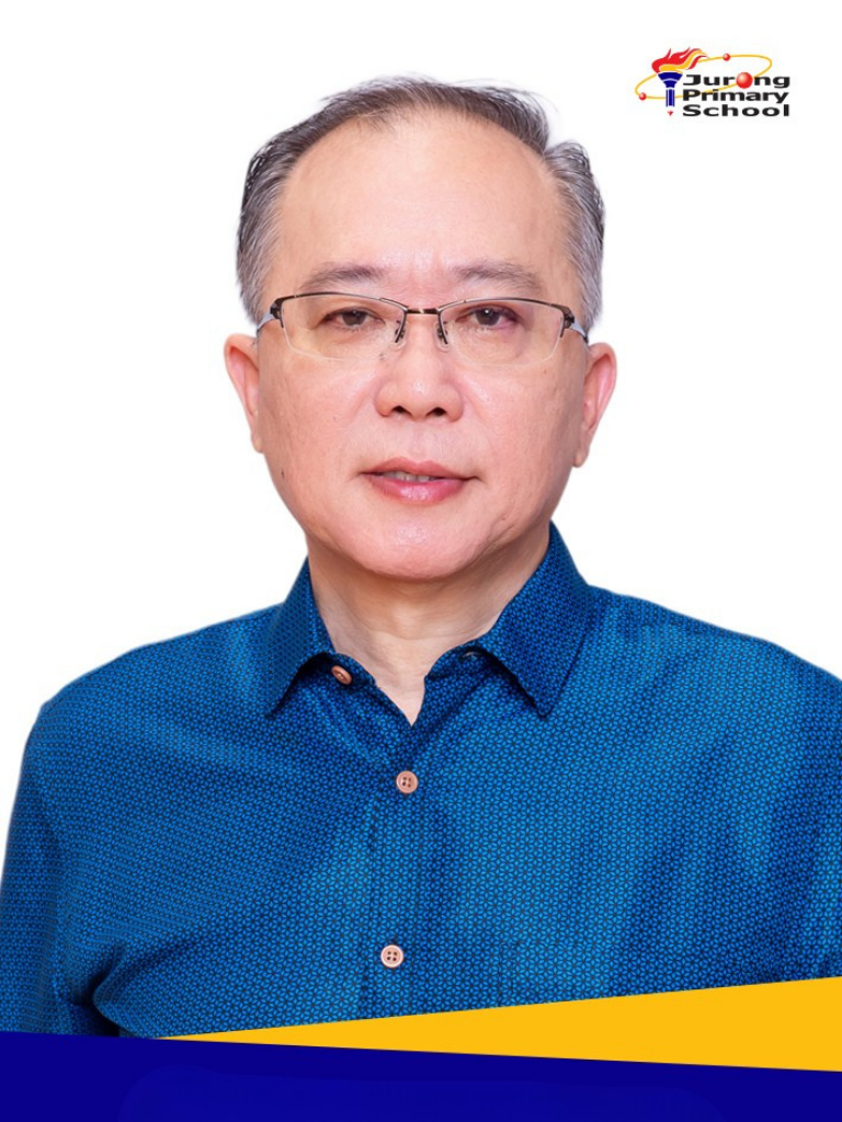 Smiling older man in blue patterned shirt, glasses, grey hair